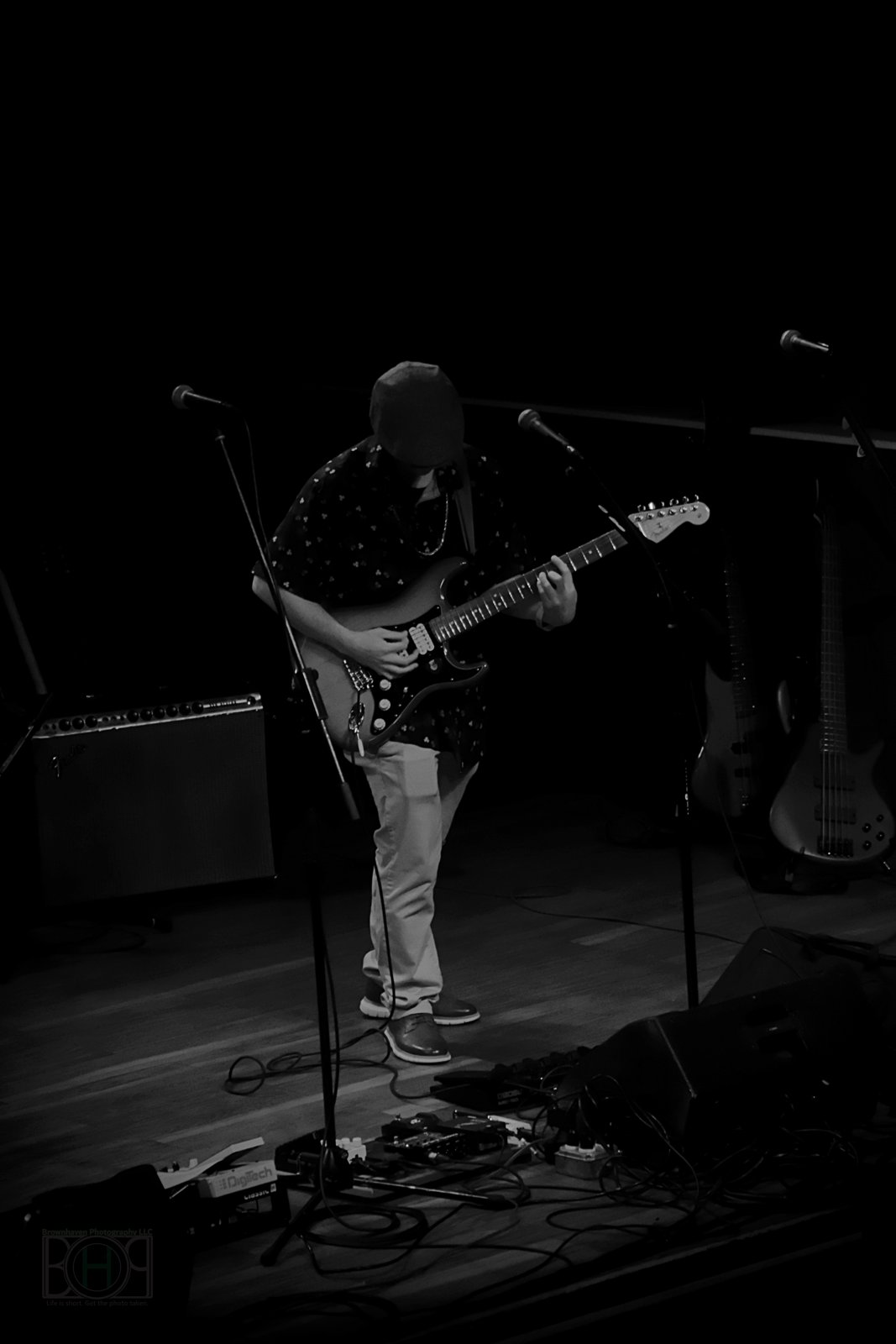Black and white photo of Austin Finnegan performing on stage