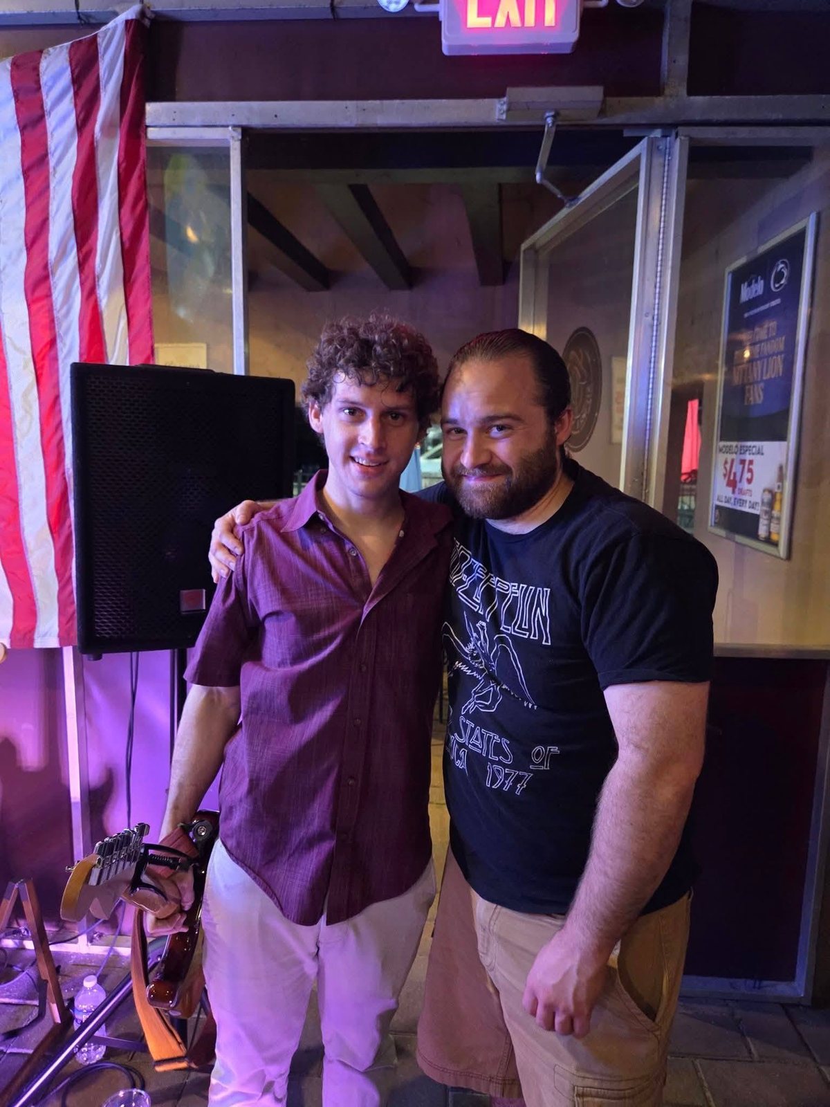 Austin Finnegan smiling with his friend Jon after his solo debut at Sierra Madre Saloon